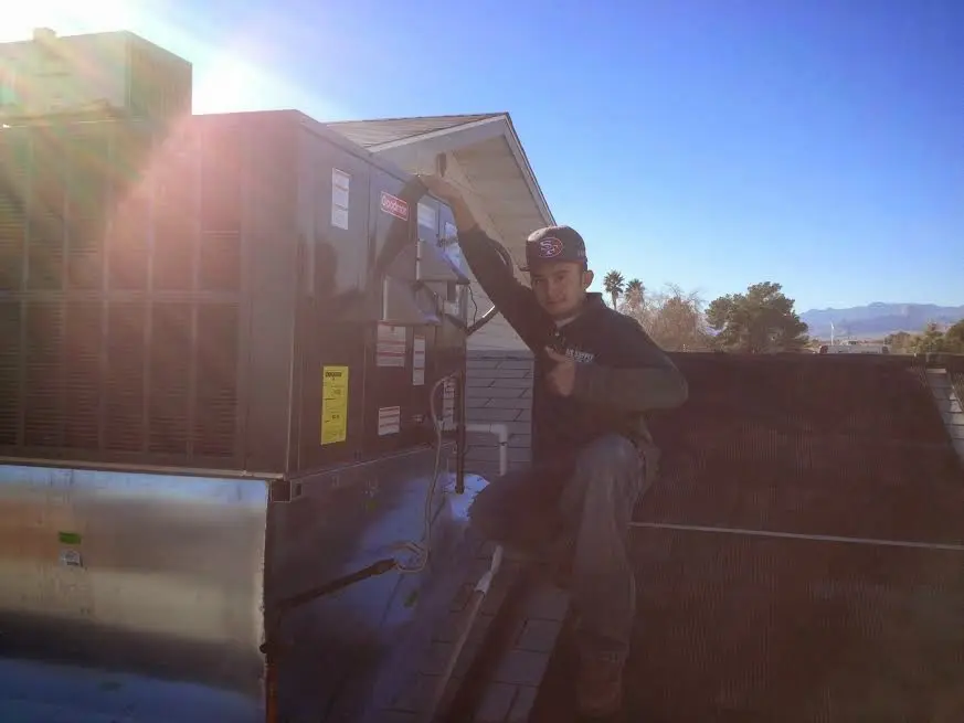 HVAC technician performing AC Tune-Up on a rooftop unit in Santa Fe Springs
